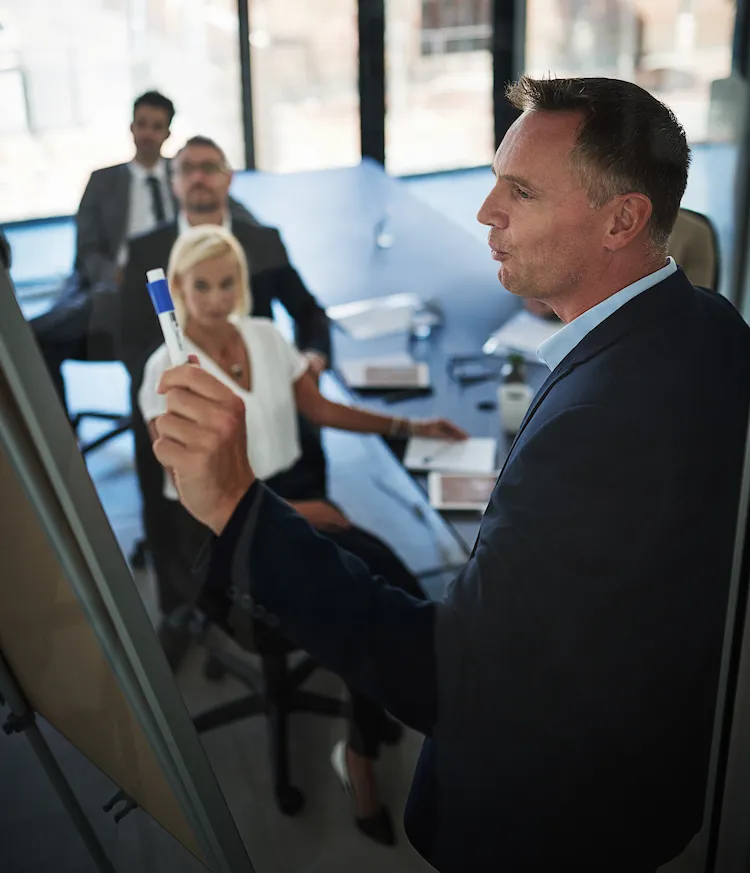 business man conducting meeting for group of business people