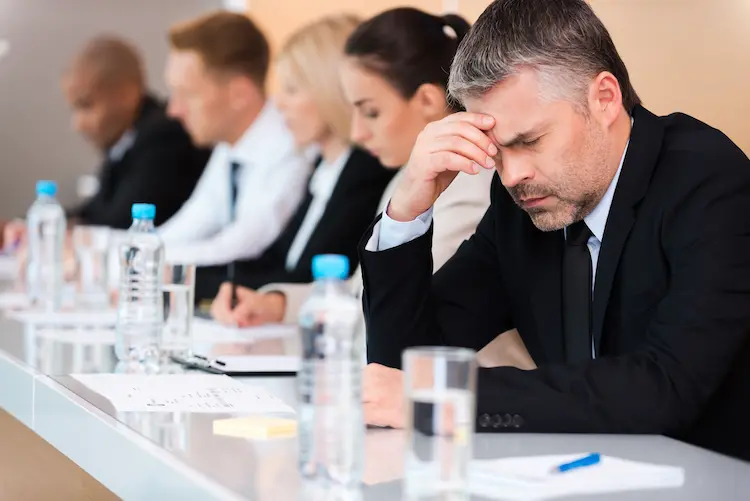 Exhausted professional at a desk late at night
