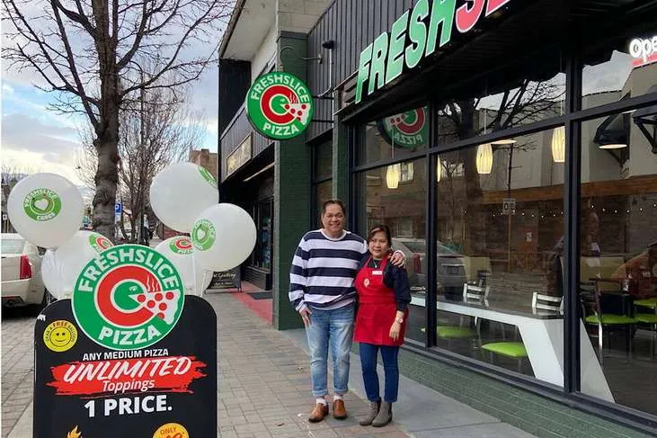 Freshslice Pizza storefront with unlimited toppings promotion