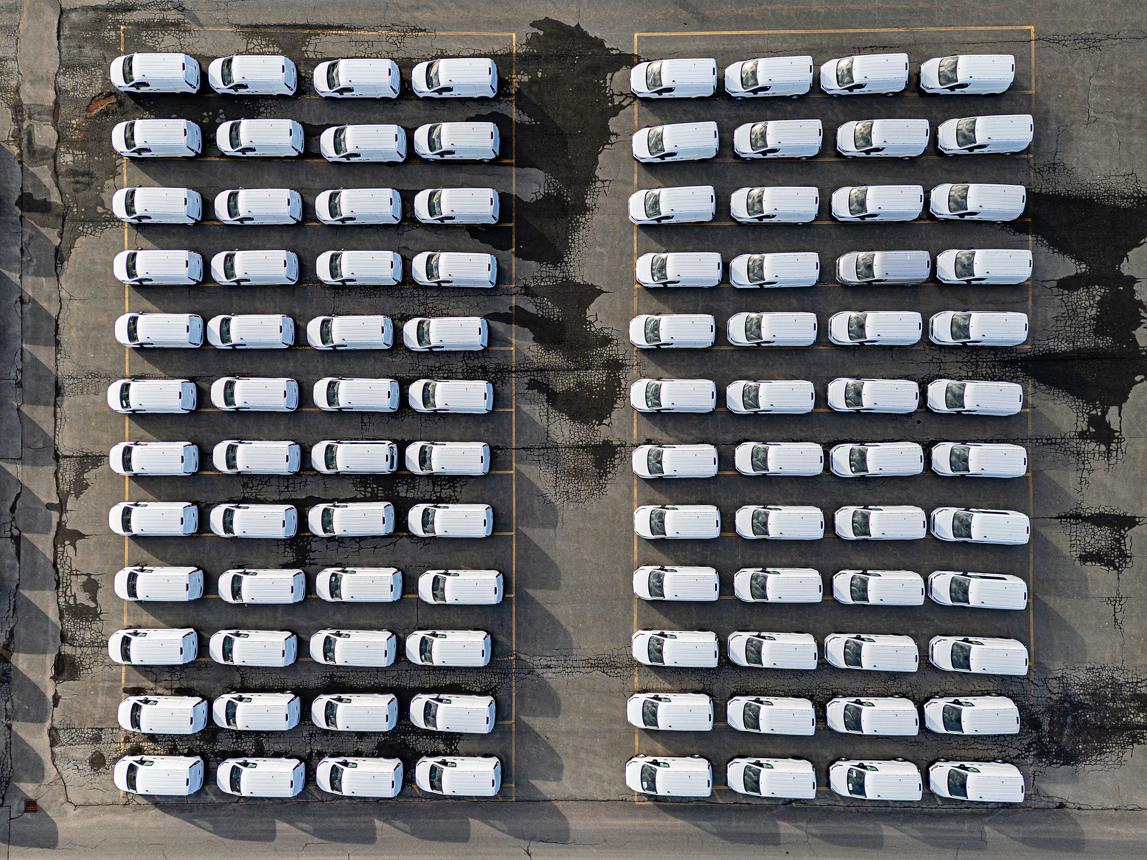 Fleet of branded service vans — a visual of the purchasing-power advantages of franchising at scale.